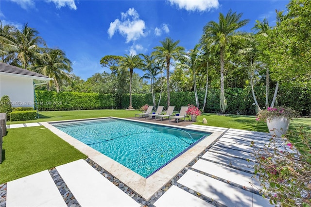 7495 SW 105th Ter, Pinecrest, FL 33156 - view of swimming pool featuring a patio, a lawn, and view of wooded area
