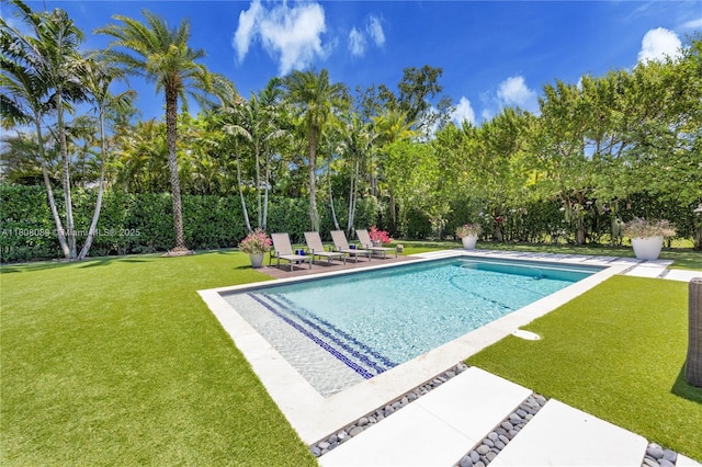 7495 SW 105th Ter, Pinecrest, FL 33156 - view of swimming pool featuring view of wooded area, a lawn, and a patio area