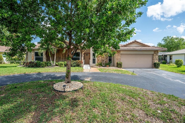 9919 SW 1st Ct, Coral Springs, FL 33071 - obstructed view of property with stone siding, asphalt driveway, a garage, a tile roof, and a front yard