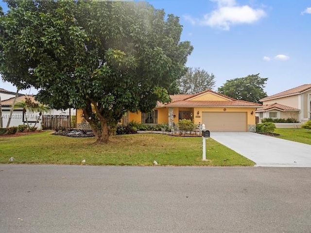 15824 Cotswold Ct, Davie, FL 33331 - view of front of house featuring an attached garage, a tile roof, a front yard, and stucco siding