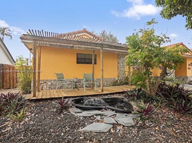 15824 Cotswold Ct, Davie, FL 33331 - back of property featuring a pergola, a deck, stucco siding, and stone siding