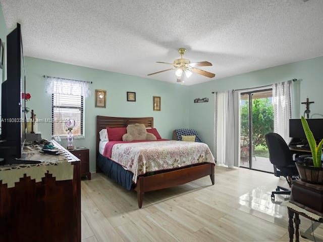 15824 Cotswold Ct, Davie, FL 33331 - bedroom featuring access to exterior, multiple windows, light wood finished floors, a textured ceiling, and an office area