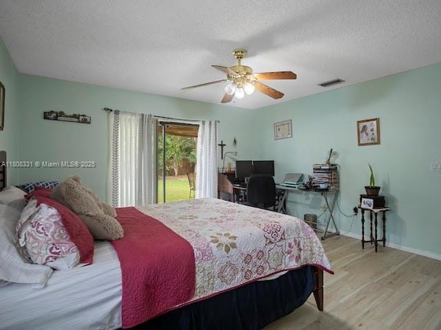 15824 Cotswold Ct, Davie, FL 33331 - bedroom with wood finished floors, a textured ceiling, ceiling fan, baseboards, and an office area