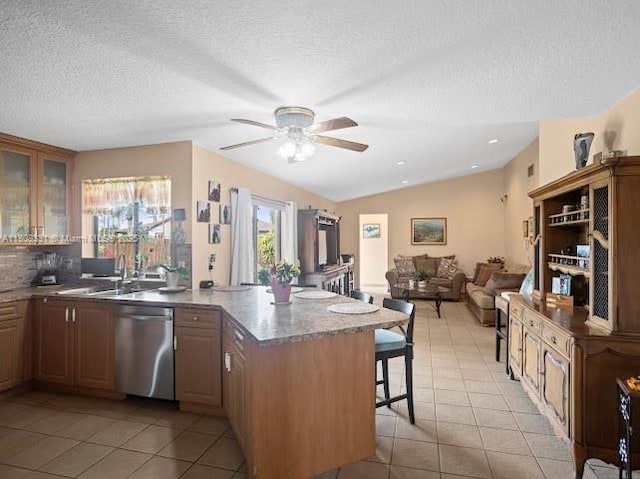 15824 Cotswold Ct, Davie, FL 33331 - kitchen with dishwasher, a peninsula, light tile patterned floors, a breakfast bar, and a textured ceiling