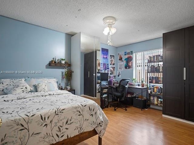15824 Cotswold Ct, Davie, FL 33331 - bedroom with an office area, light wood finished floors, and a textured ceiling