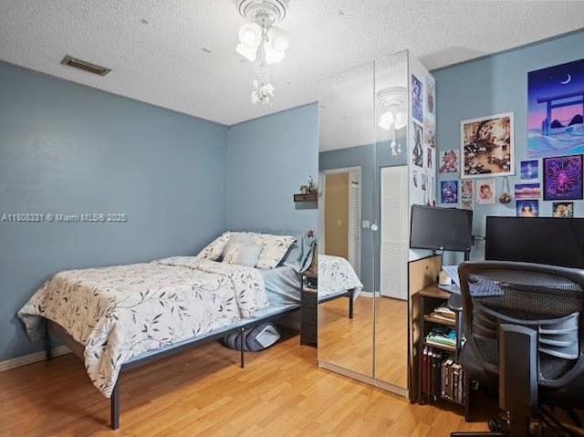15824 Cotswold Ct, Davie, FL 33331 - bedroom featuring wood finished floors, a desk, a textured ceiling, and baseboards