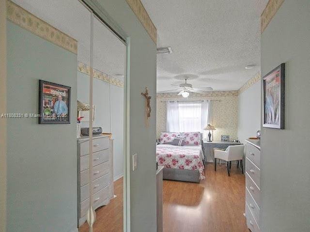 15824 Cotswold Ct, Davie, FL 33331 - bedroom with wood finished floors, a textured ceiling, and a ceiling fan