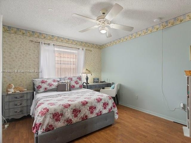 15824 Cotswold Ct, Davie, FL 33331 - bedroom featuring a textured ceiling, wood finished floors, wallpapered walls, baseboards, and ceiling fan