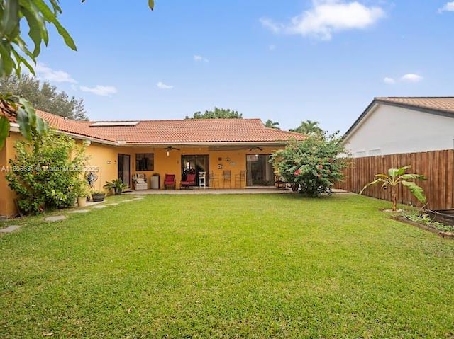 15824 Cotswold Ct, Davie, FL 33331 - back of property with ceiling fan, a tiled roof, solar panels, a patio area, and stucco siding