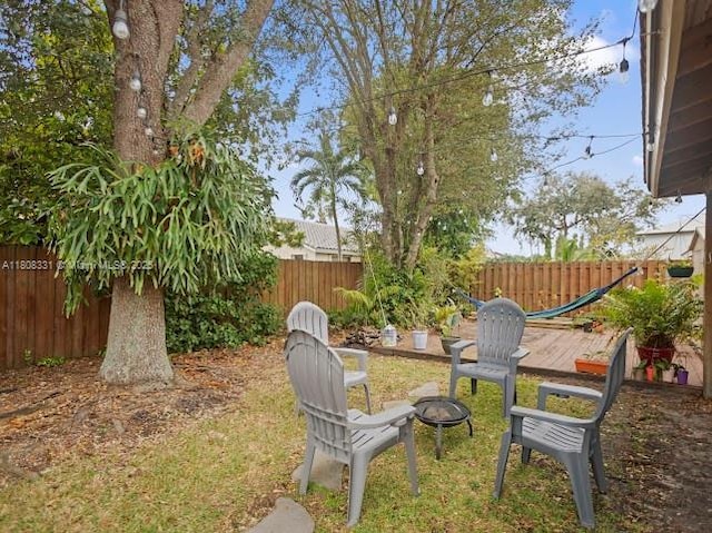 15824 Cotswold Ct, Davie, FL 33331 - fenced backyard with a fire pit
