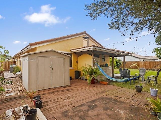 15824 Cotswold Ct, Davie, FL 33331 - back of house featuring a wooden deck and stucco siding