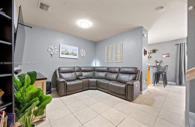 3427 W 89th Ter, Hialeah, FL 33018 - living area with light tile patterned floors, baseboards, and a textured ceiling