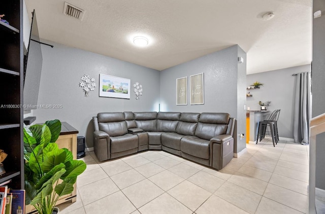 3427 W 89th Ter, Hialeah, FL 33018 - living area with light tile patterned floors, baseboards, and a textured ceiling