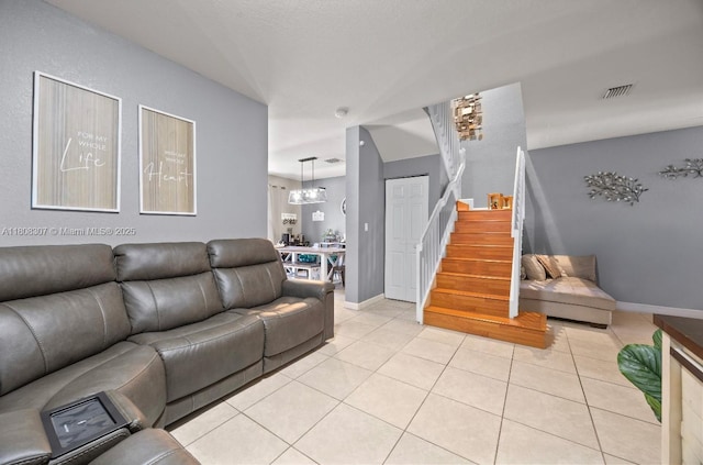 3427 W 89th Ter, Hialeah, FL 33018 - living area featuring light tile patterned floors, stairs, a chandelier, and baseboards