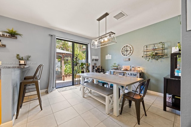 3427 W 89th Ter, Hialeah, FL 33018 - dining room featuring light tile patterned flooring, a chandelier, and baseboards