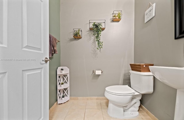 3427 W 89th Ter, Hialeah, FL 33018 - bathroom with toilet, tile patterned floors, and baseboards