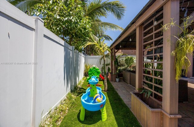 3427 W 89th Ter, Hialeah, FL 33018 - fenced backyard featuring a playground