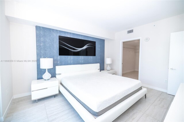 3900 Biscayne Blvd Unit S-1118, Miami, FL 33137 - bedroom with baseboards, a spacious closet, and tile patterned floors