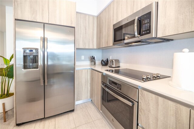 3900 Biscayne Blvd Unit S-1118, Miami, FL 33137 - kitchen featuring appliances with stainless steel finishes, light brown cabinetry, and modern cabinets