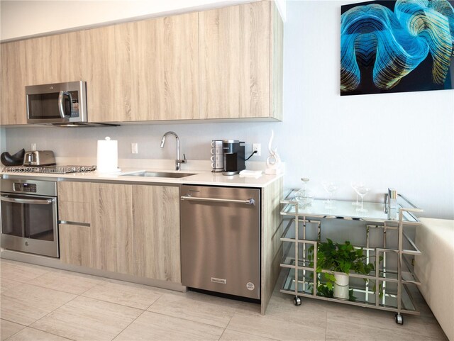 3900 Biscayne Blvd Unit S-1118, Miami, FL 33137 - kitchen featuring appliances with stainless steel finishes, modern cabinets, light brown cabinetry, a sink, and light countertops