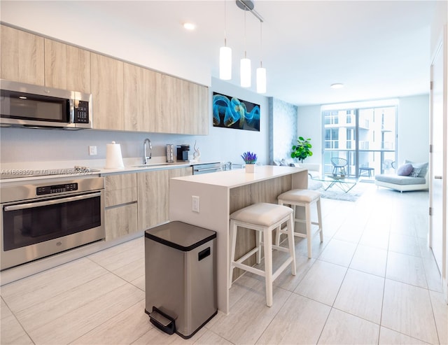 3900 Biscayne Blvd Unit S-1118, Miami, FL 33137 - kitchen featuring appliances with stainless steel finishes, light brown cabinetry, modern cabinets, a sink, and a wall of windows