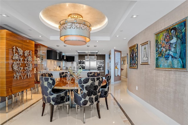 17001 Collins Ave Unit 2501, Sunny Isles Beach, FL 33160 - dining space with recessed lighting, a tray ceiling, light tile patterned flooring, and baseboards