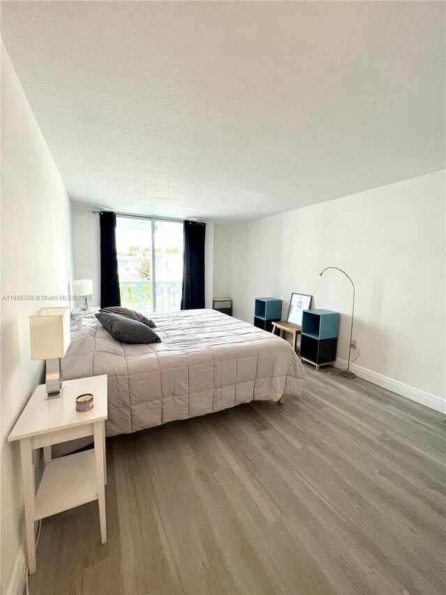 8233 Harding Ave Unit 204, Miami Beach, FL 33141 - bedroom featuring wood finished floors and baseboards