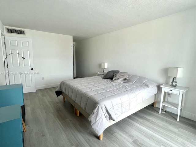 8233 Harding Ave Unit 204, Miami Beach, FL 33141 - bedroom with wood finished floors and baseboards