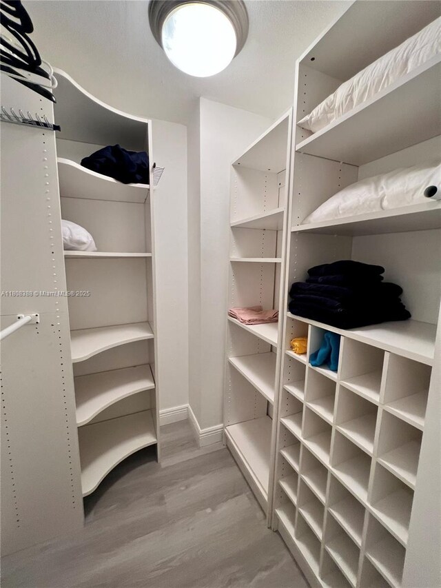 8233 Harding Ave Unit 204, Miami Beach, FL 33141 - walk in closet with wood finished floors