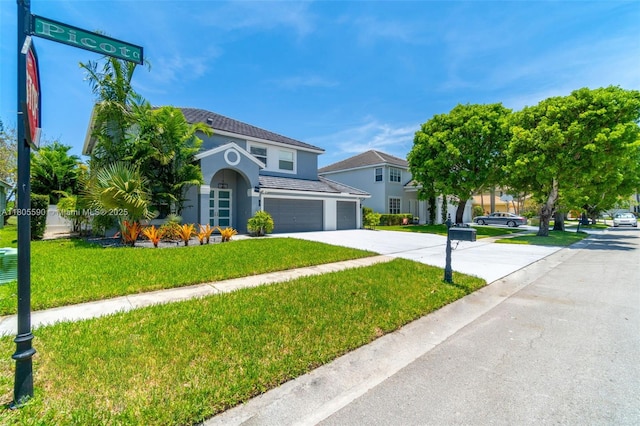 9192 Picot Ct, Boynton Beach, FL 33472 - view of front of property featuring an attached garage, stucco siding, concrete driveway, and a front lawn