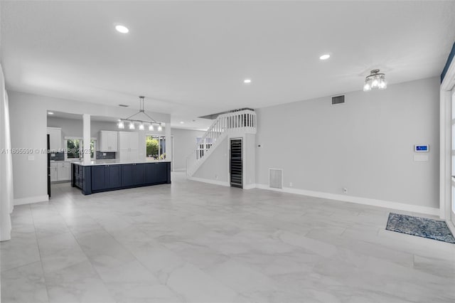 9192 Picot Ct, Boynton Beach, FL 33472 - unfurnished living room with recessed lighting, baseboards, and light marble finish flooring