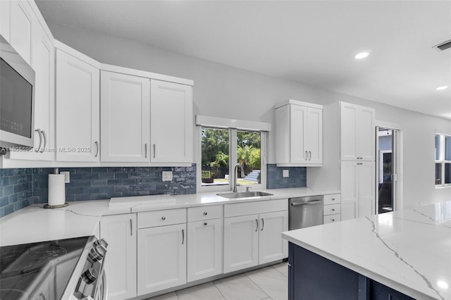 9192 Picot Ct, Boynton Beach, FL 33472 - kitchen featuring a sink, stainless steel appliances, white cabinets, and recessed lighting