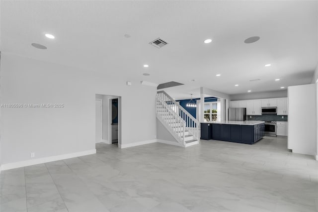 9192 Picot Ct, Boynton Beach, FL 33472 - unfurnished living room featuring baseboards, recessed lighting, light marble finish floors, and stairs