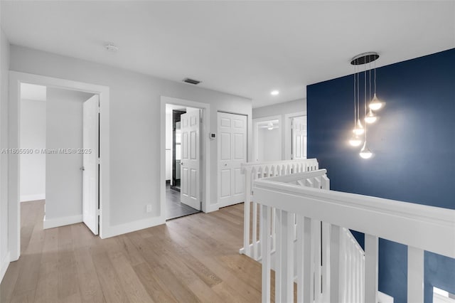 9192 Picot Ct, Boynton Beach, FL 33472 - hall with an upstairs landing, light wood-style flooring, baseboards, and recessed lighting