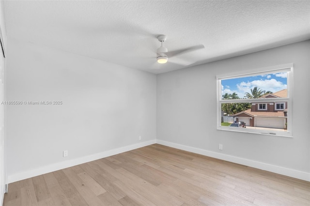 9192 Picot Ct, Boynton Beach, FL 33472 - empty room with wood finished floors, ceiling fan, baseboards, and a textured ceiling