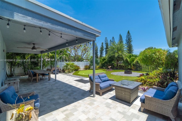 9192 Picot Ct, Boynton Beach, FL 33472 - fenced backyard featuring ceiling fan, an outdoor living space with a fire pit, and a patio area