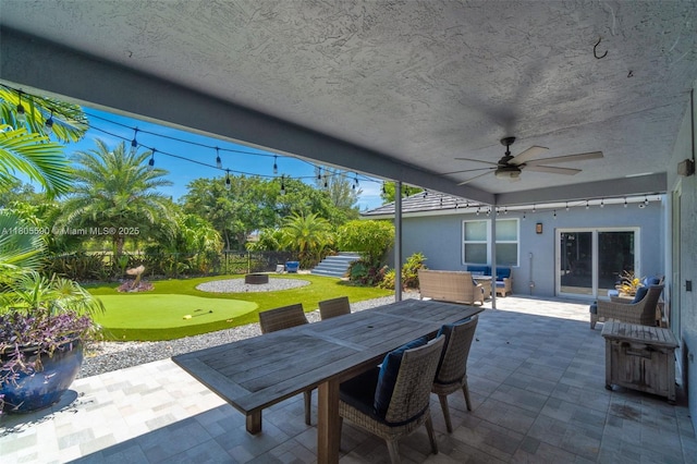9192 Picot Ct, Boynton Beach, FL 33472 - fenced backyard featuring a putting area, a patio, a ceiling fan, and outdoor dining area