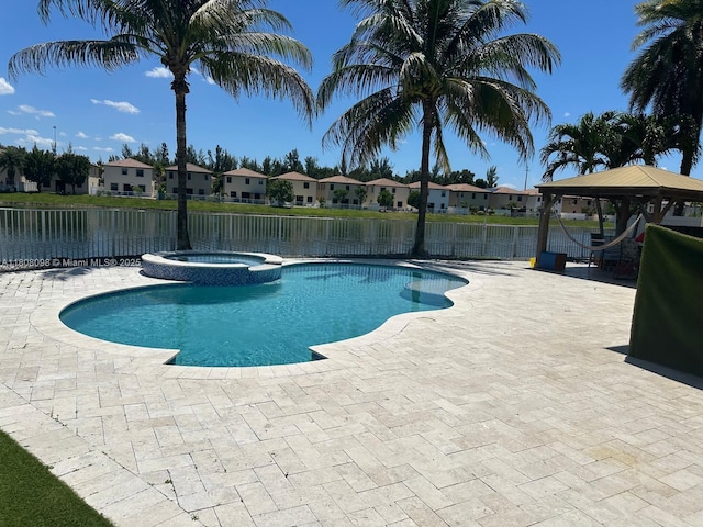 3406 W 88th St, Hialeah, FL 33018 - view of swimming pool with a gazebo, a residential view, a pool with connected hot tub, a patio area, and a water view