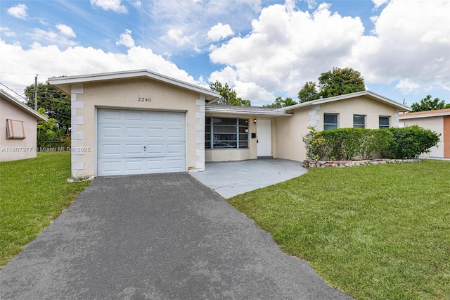 2240 NW 47th Ter, Lauderhill, FL 33313 - ranch-style home with an attached garage, stucco siding, a front yard, and driveway