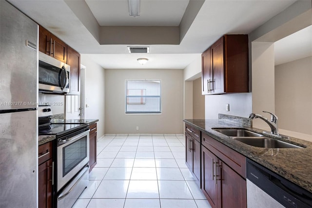 2240 NW 47th Ter, Lauderhill, FL 33313 - kitchen with appliances with stainless steel finishes, a sink, dark stone countertops, and light tile patterned floors