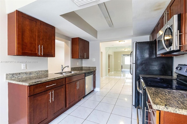 2240 NW 47th Ter, Lauderhill, FL 33313 - kitchen featuring stainless steel appliances, a sink, light tile patterned floors, baseboards, and stone countertops