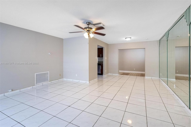 2240 NW 47th Ter, Lauderhill, FL 33313 - empty room with a ceiling fan, light tile patterned floors, and baseboards