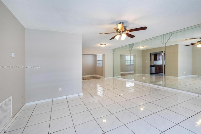 2240 NW 47th Ter, Lauderhill, FL 33313 - spare room with a ceiling fan, light tile patterned flooring, and baseboards