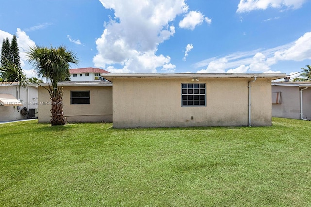 2240 NW 47th Ter, Lauderhill, FL 33313 - rear view of property with stucco siding and a yard