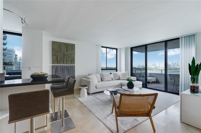 1330 W Ave Unit 902, Miami Beach, FL 33139 - living area with a city view, a wall of windows, and light tile patterned floors
