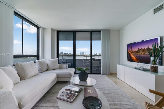 1330 W Ave Unit 902, Miami Beach, FL 33139 - living room with a wall of windows and light tile patterned floors