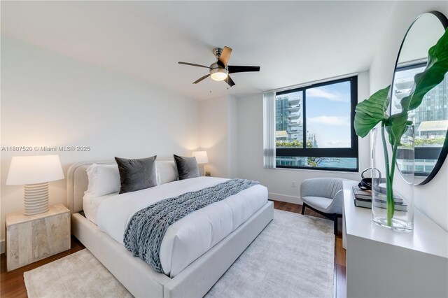 1330 W Ave Unit 902, Miami Beach, FL 33139 - bedroom with wood finished floors, baseboards, and ceiling fan