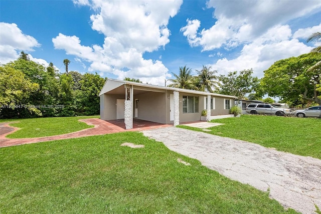 6871 SW 18th St, North Lauderdale, FL 33068 - view of front facade featuring asphalt driveway, stucco siding, a front yard, and an attached carport
