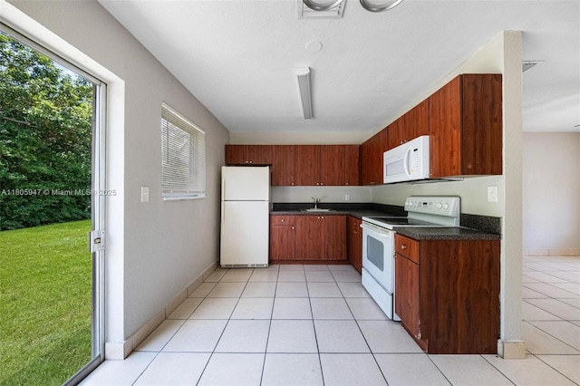 6871 SW 18th St, North Lauderdale, FL 33068 - kitchen with white appliances, dark countertops, light tile patterned floors, a sink, and baseboards