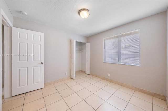 6871 SW 18th St, North Lauderdale, FL 33068 - unfurnished bedroom with a closet, light tile patterned floors, a textured ceiling, and baseboards